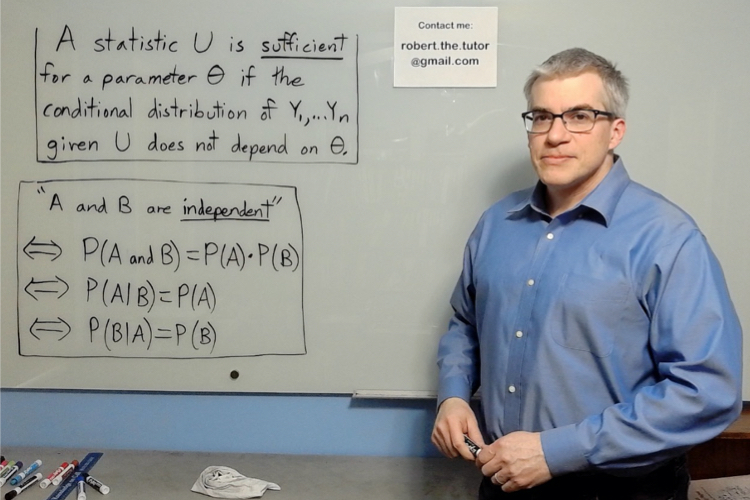 Picture of Robert standing in front of a whiteboard that contains info about sufficient statistics